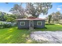 Ranch-style home with red metal roof and green lawn at 3331 Se 11Th Ave, Ocala, FL 34471