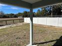Private backyard with a white vinyl fence and open views of a rural landscape at 1696 Sw 144Th Ct, Ocala, FL 34481