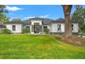 Beautiful new construction home with a lush green lawn at 925 Se 13Th St, Ocala, FL 34471