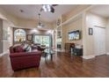 Spacious living room with hardwood floors, fireplace, large window with natural light, and comfortable seating at 4348 Sw Deepwater Ct, Dunnellon, Fl, FL 34431