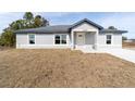 Newly built home with gray siding and a gray roof at 14293 Sw 32Nd Pl, Ocala, FL 34481