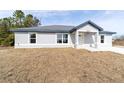 New construction home with gray siding and a landscaped yard at 14293 Sw 32Nd Pl, Ocala, FL 34481