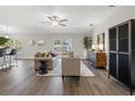 Open concept living area with hardwood floors, a neutral color palette, and modern furniture at 7128 Sw 134Th St, Ocala, FL 34473