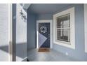 Blue front door with a wreath and a window on the porch with textured blue walls at 4560 Sw 52Nd Cir # 101, Ocala, FL 34474