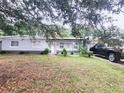 Gray house with a well-maintained lawn and a driveway at 1147 Northcrest Dr, Apopka, FL 32703