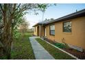 House exterior showcasing walkway and welcome sign at 147 Juniper Run, Ocala, FL 34480