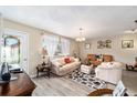 Inviting living room with hardwood floors, plush seating, and natural light from the windows at 10978 Sw 83Rd Ave, Ocala, FL 34481