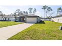 New construction home featuring a well-manicured lawn and a two-car garage at 13392 Sw 63Rd Ter, Ocala, FL 34473