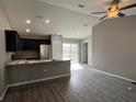 Open living room and kitchen area with vinyl plank floors at 4030 Se 134Th St, Belleview, FL 34420