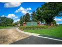 The Irish Acres community entrance features manicured landscaping and a brick sign under a blue sky at 1934 Nw 79Th Loop, Ocala, FL 34475