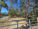 Gated driveway leading to the house with treelined lot at 3174 Sw 189Th Ave, Dunnellon, FL 34432