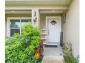 Inviting front porch with landscaping, white door, and welcoming decor at 4660 Sw 130Th St, Ocala, FL 34473