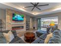 Spacious living room featuring a stone fireplace and large TV at 9124 Sw 84Th Ln, Ocala, FL 34481