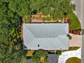 Aerial view of the home's roof surrounded by mature trees and lush landscaping at 17808 Se 115Th Ct, Summerfield, FL 34491