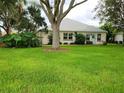Well-maintained lawn and landscaping enhance this quaint single story home with white exterior at 17808 Se 115Th Ct, Summerfield, FL 34491