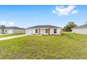 Inviting single-Gathering home with a neat lawn, showcasing the home's modern design and attached garage at 3674 Sw 149 Ter, Ocala, FL 34481