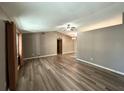 Open-concept living area with wood floors and natural light at 5877 Nw 64Th St, Ocala, FL 34482