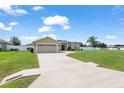 House with a two-car garage and a long driveway at 9818 Sw 51St Ct, Ocala, FL 34476