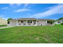 Cozy single-story home with a well-manicured lawn and charming white picket fence in daylight at 10820 Sw 87Th Ter, Ocala, FL 34481
