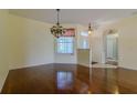 Cozy dining room with hardwood floors, ornate chandelier, and ample natural light, perfect for intimate gatherings at 15268 Sw 14Th Avenue Rd, Ocala, FL 34473