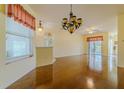 Open-concept living space boasts hardwood floors, elegant lighting, and seamless transition to the outdoors through sliding doors at 15268 Sw 14Th Avenue Rd, Ocala, FL 34473