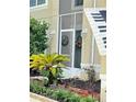 Front entrance with a screened door and landscaping at 2733 Scarborough Dr, Kissimmee, FL 34744