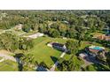 Picturesque aerial view of the property surrounded by mature trees in a serene neighborhood at 4011 Se 47Th Pl, Ocala, FL 34480