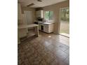 Functional kitchen area with tile flooring and backyard access at 4 Spring Trl, Ocala, FL 34472