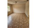 Spacious living room featuring tile floors and a ceiling fan at 4 Spring Trl, Ocala, FL 34472