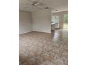 Open living room with tile floors adjacent to the kitchen area at 4 Spring Trl, Ocala, FL 34472
