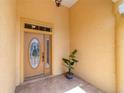 Close up of an elegant front door featuring decorative glass and textured walls at 8463 Sw 84Th Loop, Ocala, FL 34481