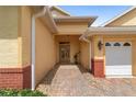 Welcoming front entrance with a brick walkway leading to an elegant front door at 8463 Sw 84Th Loop, Ocala, FL 34481