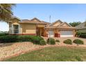 Charming home with lush landscaping, decorative rock beds, and a brick-accented exterior at 8463 Sw 84Th Loop, Ocala, FL 34481