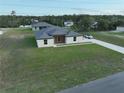 Aerial view of a modern single-Gathering home with a long driveway and spacious green lawn at 10107 Sw 41St Ave, Ocala, FL 34476