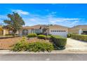 Well maintained home featuring a lawn with lush shrubbery, ample parking, and an attached two car garage at 9882 Sw 89Th Lane Rd, Ocala, FL 34481