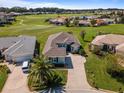 Beautiful home featuring lush landscaping and a well-manicured lawn in a golf community at 12333 Se 177Th Loop, Summerfield, FL 34491