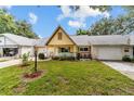 Inviting single-story home with a covered front porch, lush lawn, and mature trees for a serene setting at 9357 Sw 82Nd Ter # B, Ocala, FL 34481