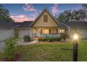 Charming single-story home featuring a cute front porch with an A-frame roof during dusk at 9357 Sw 82Nd Ter # B, Ocala, FL 34481