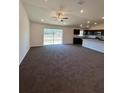 Bright open floor plan features sliding glass doors and a ceiling fan at 6272 Sw 155 Street Rd, Ocala, FL 34473