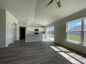 Open floor plan of living area flowing into the kitchen with access to the backyard at 6272 Sw 155 Street Rd, Ocala, FL 34473