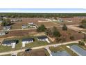 Aerial view of a developing community featuring single-Gathering homes on spacious lots surrounded by natural landscapes at 3654 Sw 149 Ter, Ocala, FL 34481