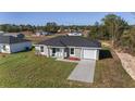 Inviting single-Gathering home featuring an attached garage, and lush lawn, perfect for comfortable living at 3654 Sw 149 Ter, Ocala, FL 34481