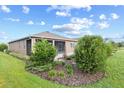 Beautiful backyard featuring a screened-in patio and lush landscaping including flower beds and shrubs at 7709 Sw 86Th Ct, Ocala, FL 34481