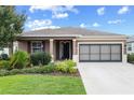 Well-maintained home exterior with manicured lawn, dark shutters and inviting front entrance at 7709 Sw 86Th Ct, Ocala, FL 34481