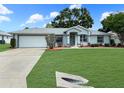 Charming single-story home featuring a well-manicured lawn and a classic architectural design at 4937 Nw 30Th Pl, Ocala, FL 34482