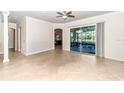 Spacious living room featuring neutral tones and large sliding glass doors leading to outdoor living space at 6925 Se 96Th Place Rd, Belleview, FL 34420