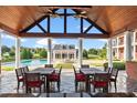Charming poolside patio with dining area and views of the main house and pool at 17800 Se 237Th Ct, Umatilla, FL 32784