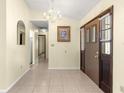 Bright entryway with tiled floors and a chandelier at 21406 Sw Plantation St, Dunnellon, FL 34431