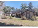 Tan house with a dark roof and landscaping at 4215 Se 24Th Ter, Ocala, FL 34480