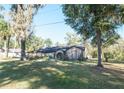 Single-story house with a large yard and mature trees at 4215 Se 24Th Ter, Ocala, FL 34480